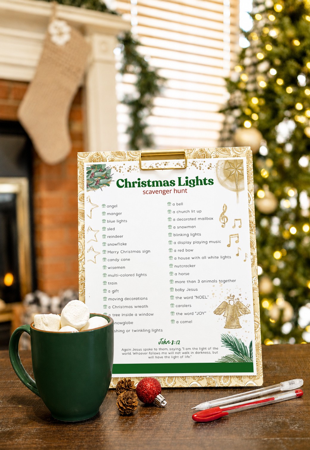 Christmas lights printable on a clipboard with hot cocoa