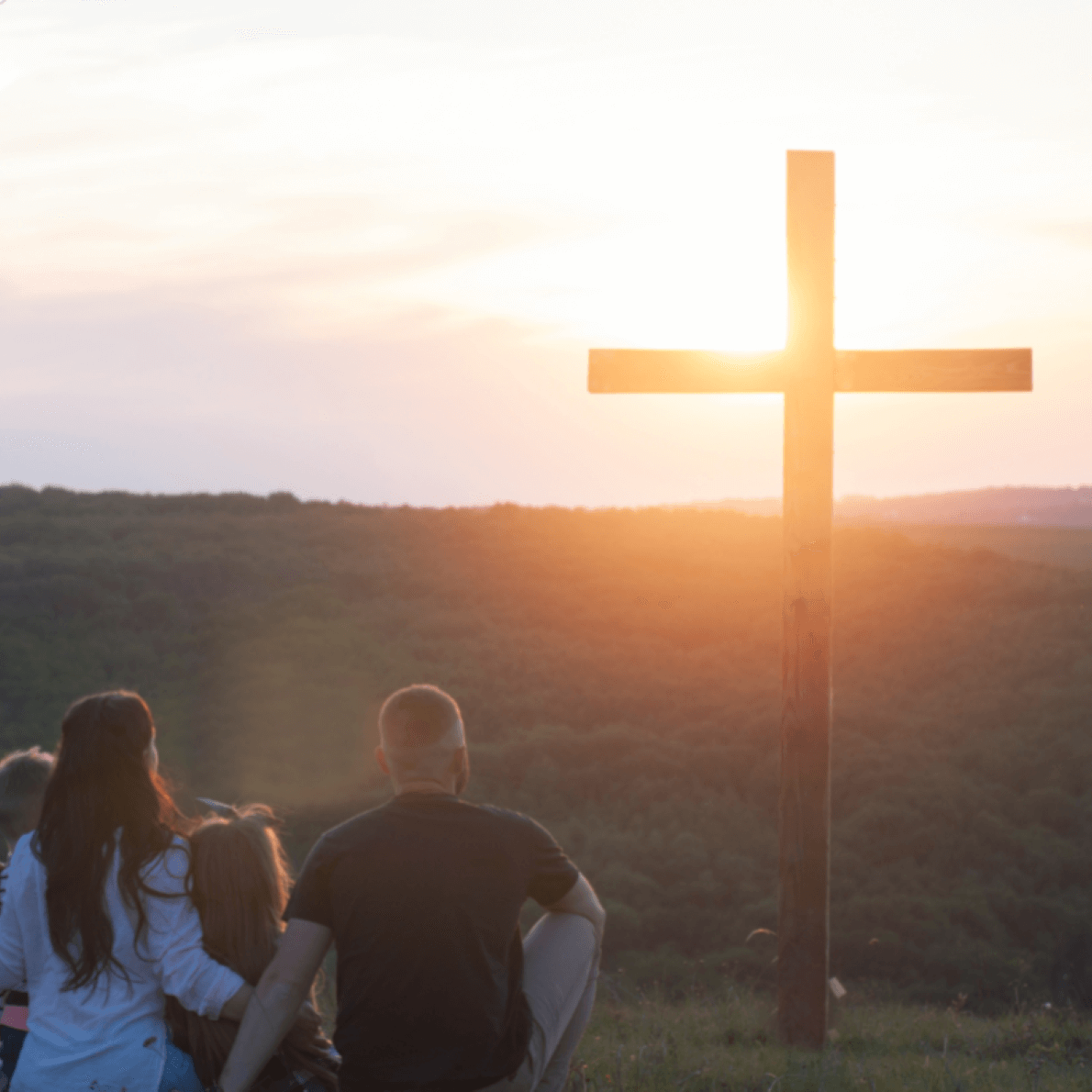 family looking at cross to celebrate Easter