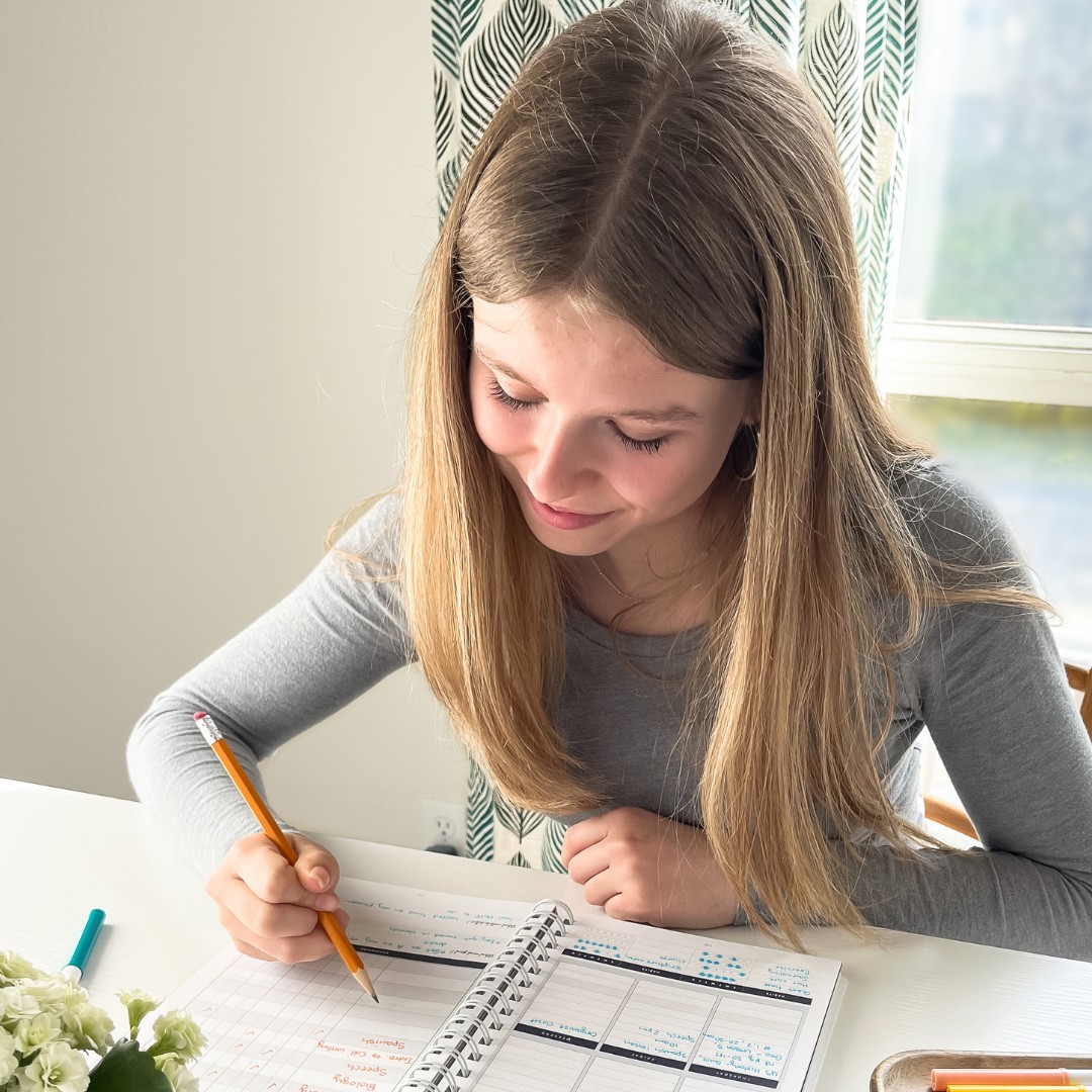 homeschool girl working at a desk with her homework to fulfill her transcript