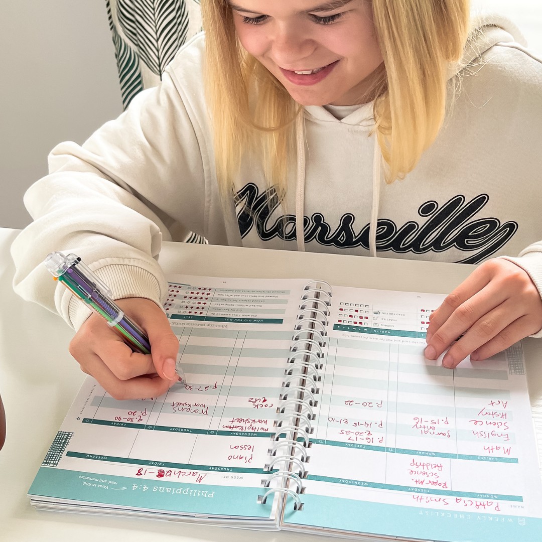 Homeschool girl filling out her morning routine planner