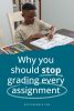 Why you should stop grading every assignment in white text over a blue background with a homeschool boy doing his school work